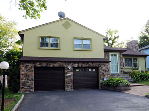 Split level house completed with stucco and stone in Montclair